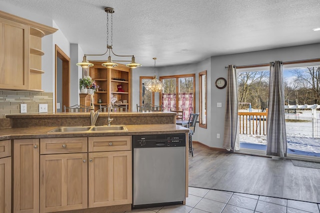 kitchen featuring light tile patterned floors, decorative backsplash, light brown cabinetry, stainless steel dishwasher, and sink