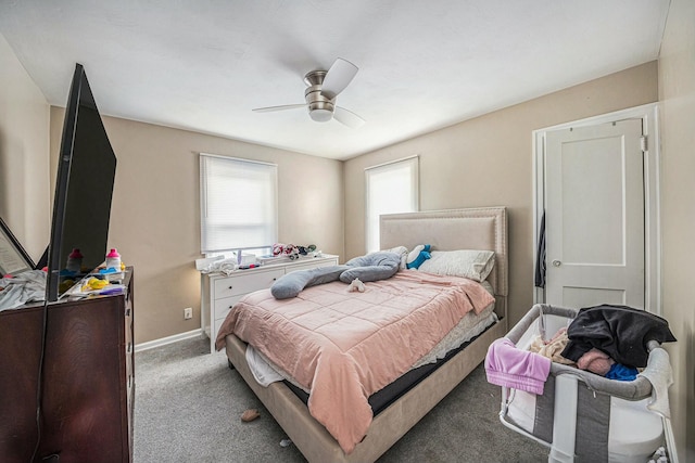 carpeted bedroom with ceiling fan and baseboards