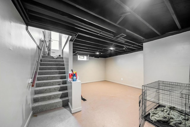 basement with stairway and baseboards