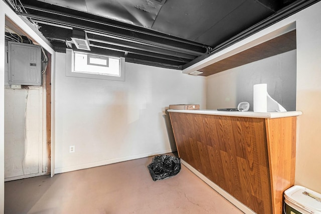 bar with electric panel, baseboards, and concrete floors