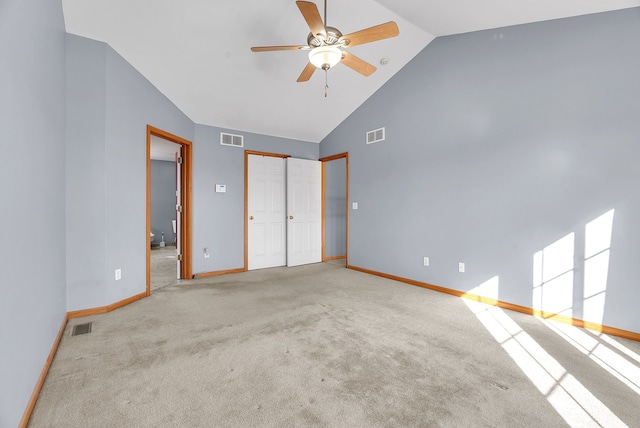 unfurnished bedroom featuring vaulted ceiling, ceiling fan, and light colored carpet