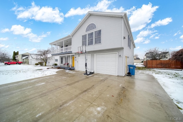 view of property with a balcony and a garage