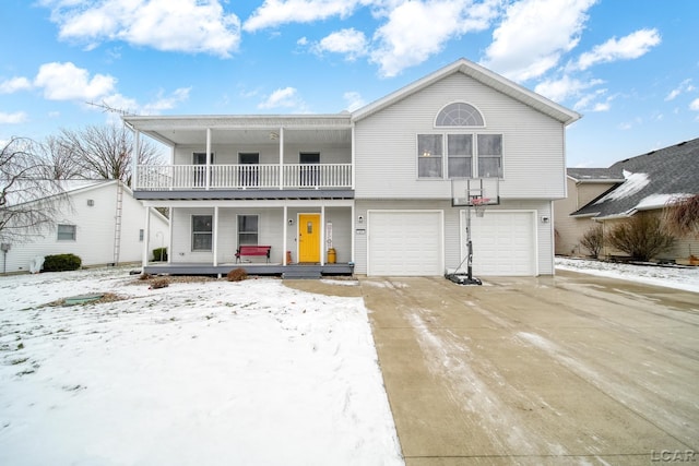 view of front of property featuring a garage, a balcony, and covered porch