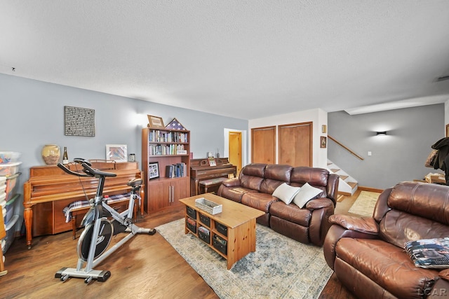 living room with hardwood / wood-style floors and a textured ceiling