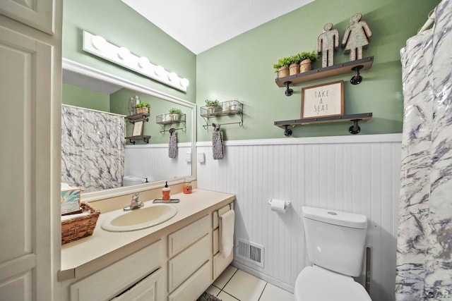 bathroom featuring toilet, tile patterned flooring, and vanity