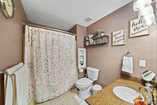 bathroom featuring vanity, toilet, and tile patterned flooring