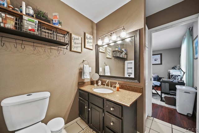 bathroom with tile patterned floors, vanity, and toilet