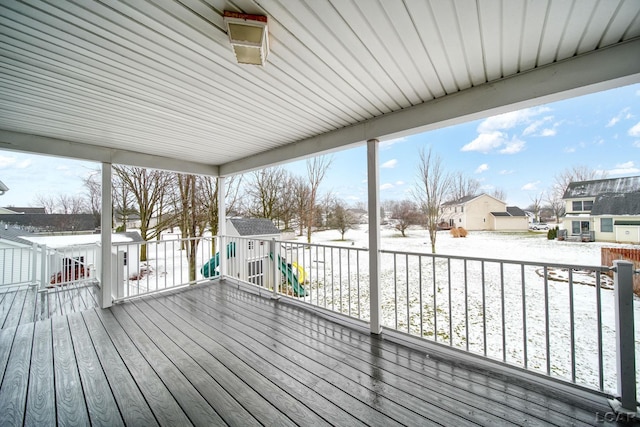 snow covered deck with a storage unit