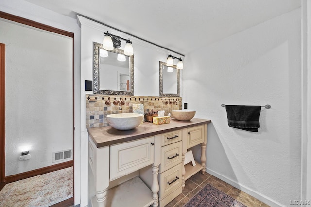 bathroom featuring vanity, tile patterned floors, and decorative backsplash