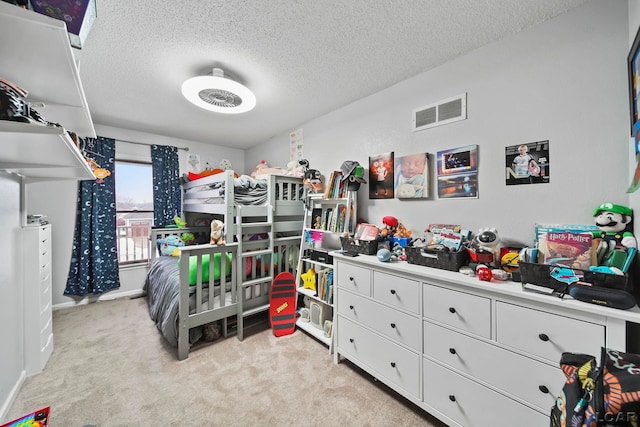 carpeted bedroom with a textured ceiling