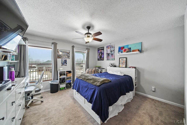 carpeted bedroom featuring ceiling fan and a textured ceiling