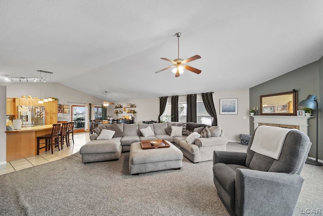 living room with ceiling fan, track lighting, light carpet, and lofted ceiling