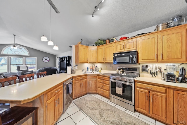 kitchen with pendant lighting, stainless steel appliances, sink, kitchen peninsula, and light tile patterned flooring