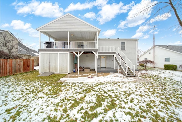 view of snow covered back of property