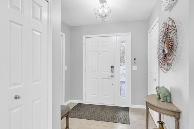 entryway with an inviting chandelier