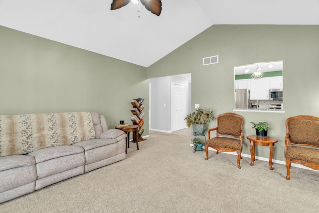 carpeted living room with lofted ceiling and ceiling fan