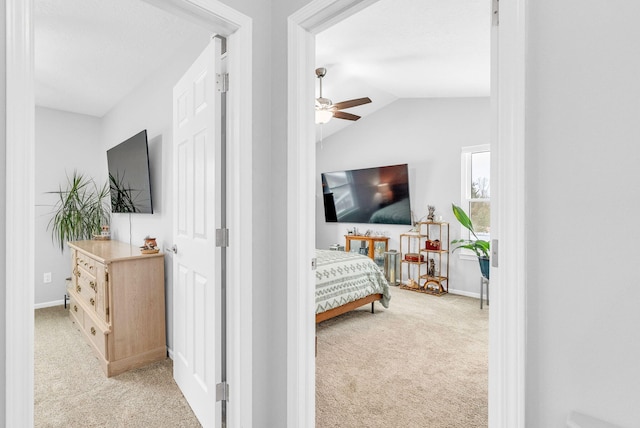 bedroom with ceiling fan, light colored carpet, and lofted ceiling