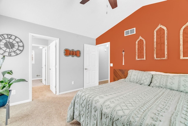 bedroom with ceiling fan, light colored carpet, and vaulted ceiling