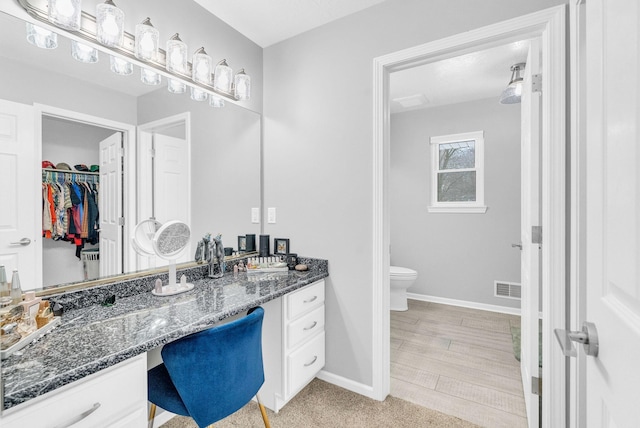 bathroom with toilet and vanity