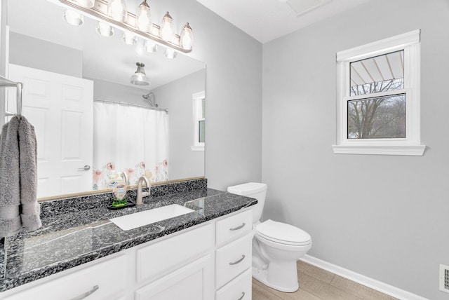 bathroom featuring toilet and vanity