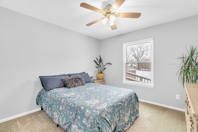 bedroom with ceiling fan and light colored carpet