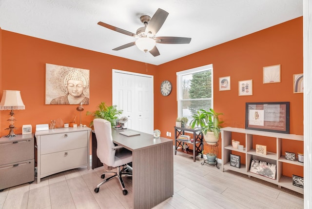 office space featuring ceiling fan and light wood-type flooring