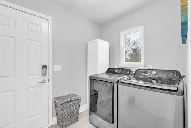 clothes washing area featuring independent washer and dryer