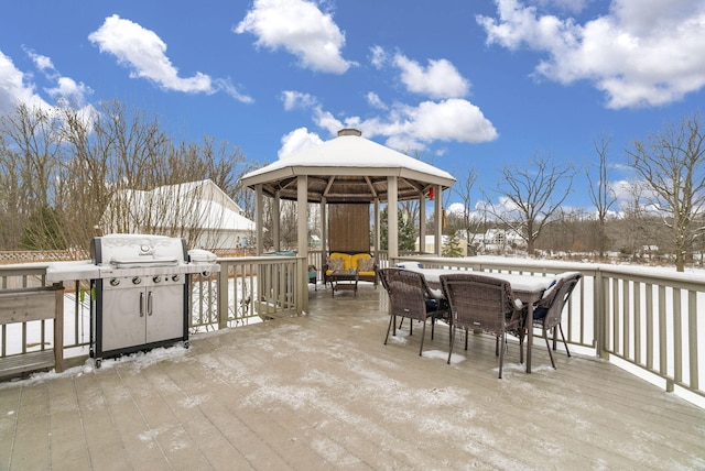 snow covered patio featuring a deck, area for grilling, and a gazebo