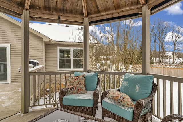 sunroom featuring lofted ceiling and wooden ceiling