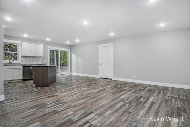 kitchen with dishwasher, a center island, decorative backsplash, sink, and white cabinets