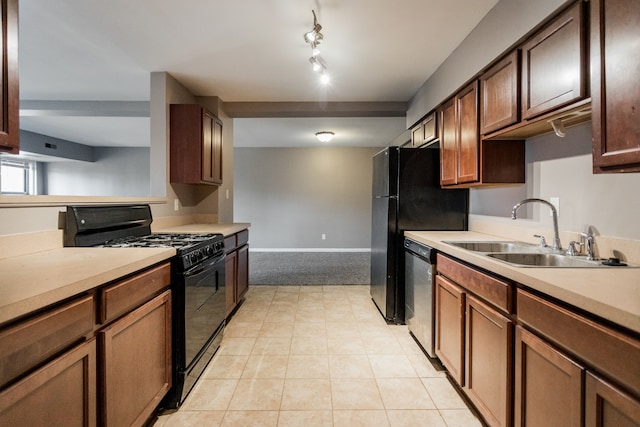 kitchen featuring black range with gas stovetop, dishwasher, and sink