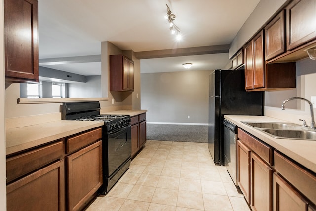 kitchen featuring sink, light tile patterned floors, stainless steel dishwasher, and gas stove