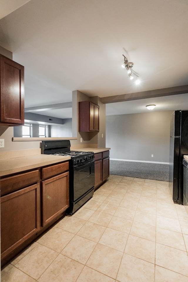 kitchen featuring track lighting, black appliances, and light tile patterned flooring