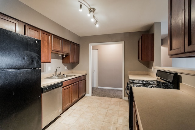 kitchen featuring light tile patterned flooring, sink, and black appliances