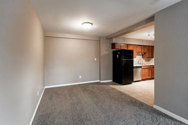 kitchen with dishwasher, black fridge, sink, and light colored carpet