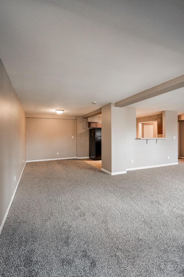 unfurnished living room featuring carpet flooring