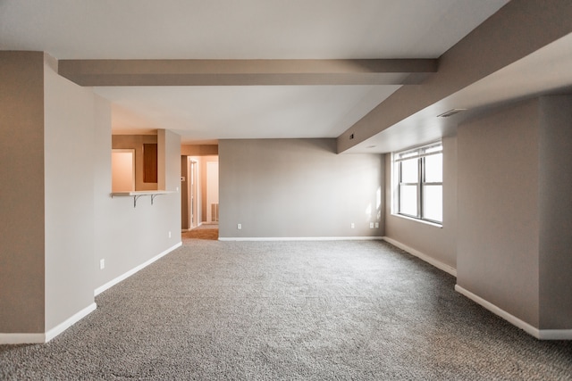 unfurnished living room with beam ceiling and carpet