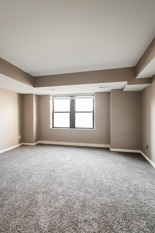 unfurnished room featuring carpet and a wealth of natural light