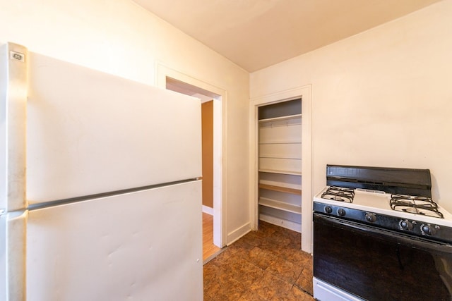 interior space featuring white refrigerator and gas range