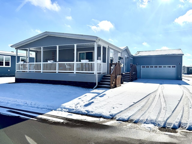 manufactured / mobile home with covered porch and a garage