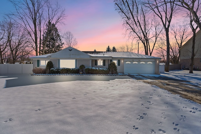 ranch-style home featuring a garage