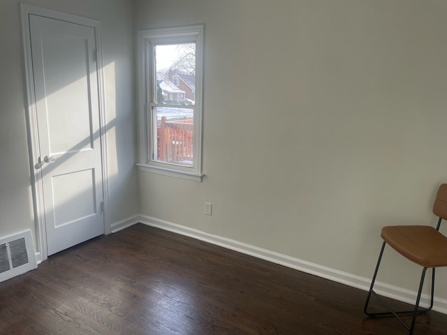 unfurnished room featuring dark wood-type flooring