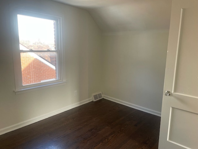 additional living space with dark hardwood / wood-style floors and lofted ceiling