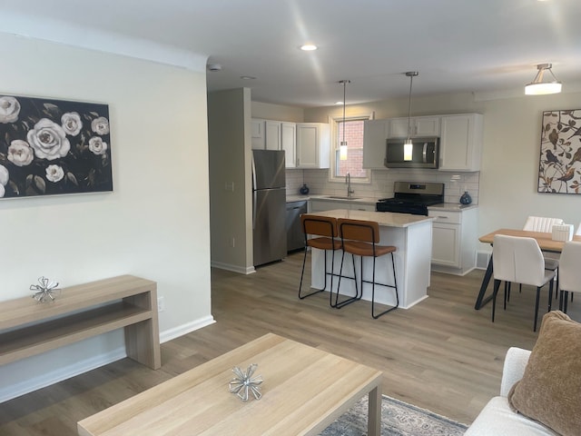 living room with sink and wood-type flooring