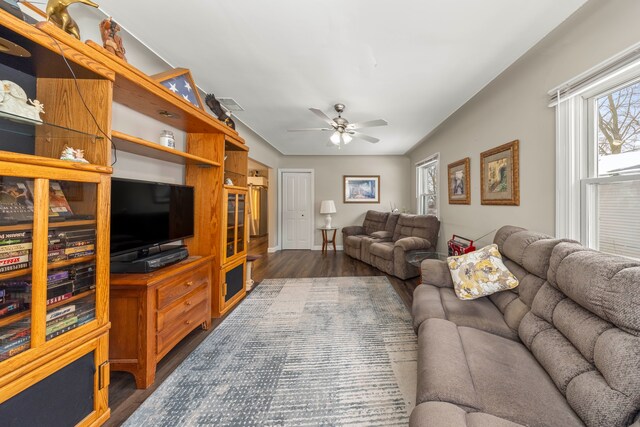 living room with dark hardwood / wood-style floors and ceiling fan