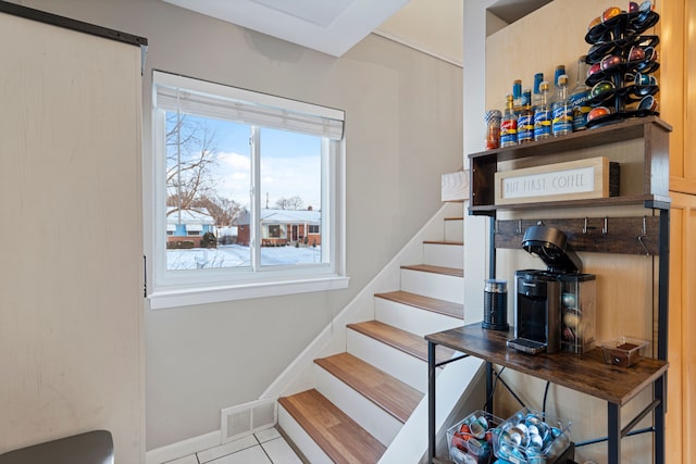 stairs featuring tile patterned flooring