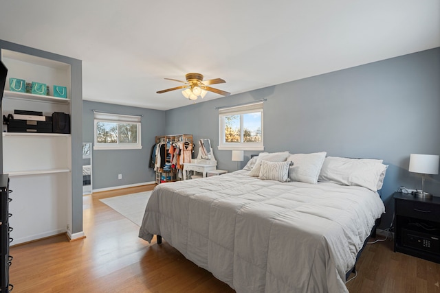 bedroom with ceiling fan and hardwood / wood-style floors