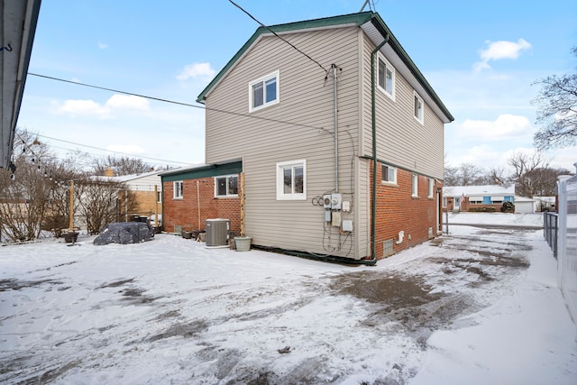 snow covered property featuring cooling unit