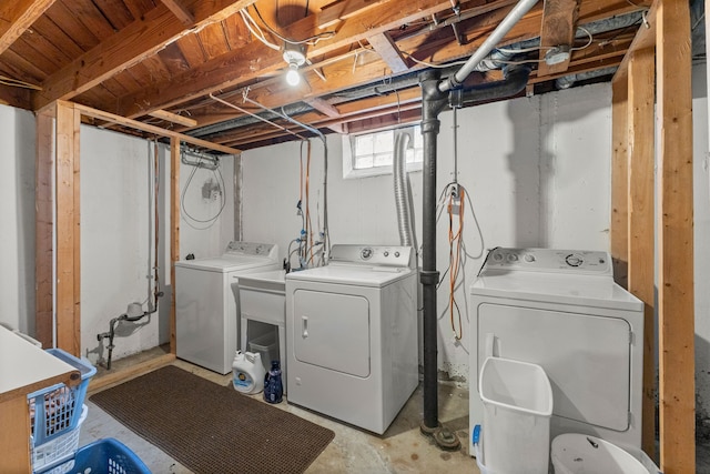 clothes washing area with washer and clothes dryer