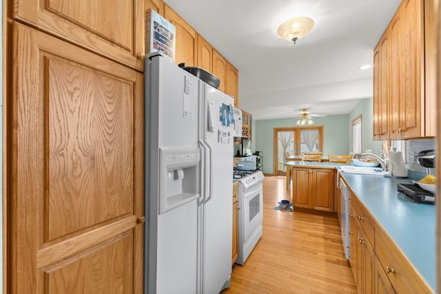 kitchen featuring light wood-type flooring, ceiling fan, light brown cabinets, and white appliances